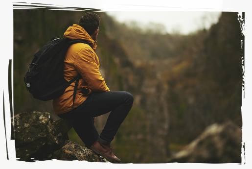 Man on Rock Man perched on rock outdoors