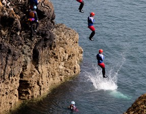 People jumping into the sea