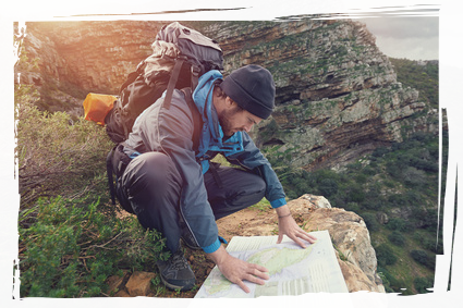 Man looking at map whilst hiking