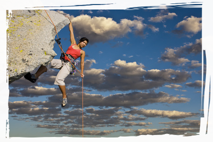 Woman climbing rock face