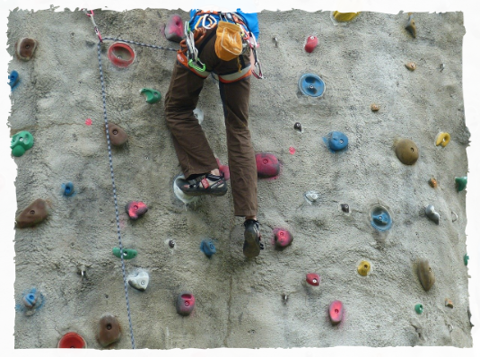 Active climbing indoors Person on artificial climbing wall