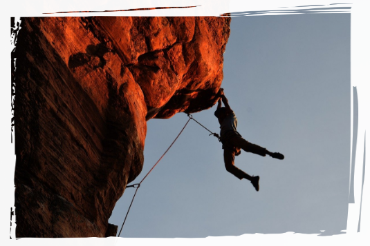 Person climbing rock face