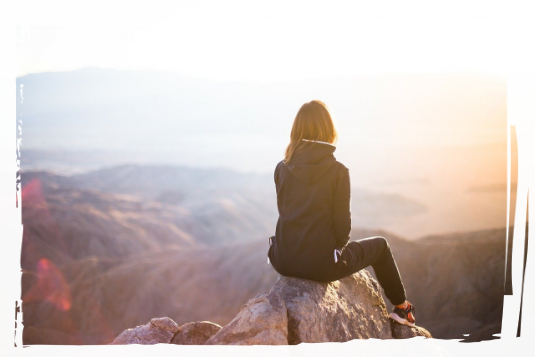 Sitting on a peak Person on a mountain