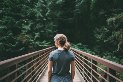 Woman walking over bridge